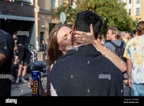 Woman Kissing A Man While Holding To A Drink Can At Kallio Block Party 2023 In Helsinki Finland
