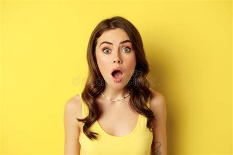 close up portrait of stylish brunette girl looking amazed wow face showing excitement and