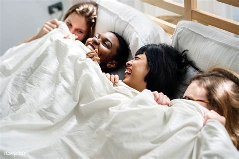 Download Premium Image Of Group Of Diverse Women Lying On Bed Together