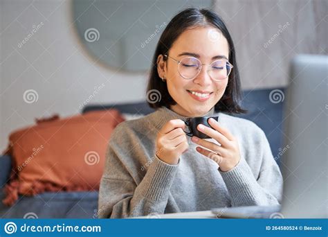 Close Up Portrait Of Beautiful Asian Woman Drinks Her Coffee Smells