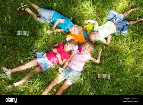 Happy Kids Lying On Grass Stock Photo Alamy