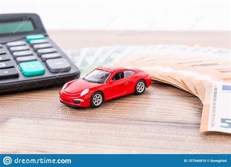 Do red cars cost more to insure? Insurance, Loan And Buying Car Concept. Red Car And Euro Banknotes. Calculator, Euro Money And ...