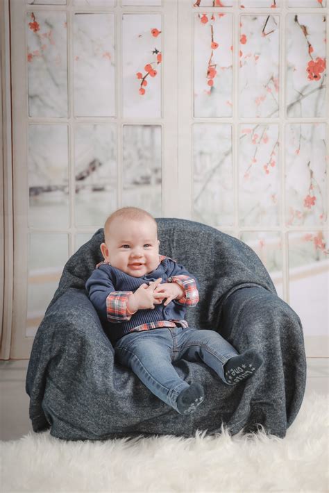 A high chair makes feeding a baby a whole lot easier experience for a new mom. Baby Sitting on Sofa Chair · Free Stock Photo