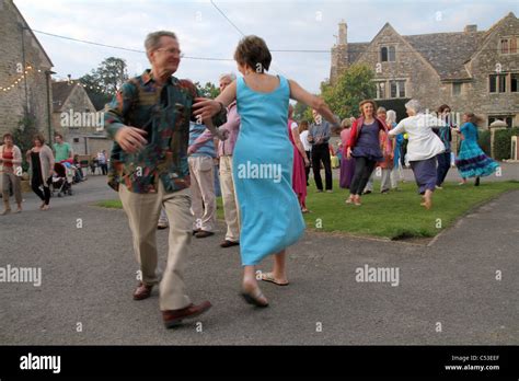 Peple Dance To Traditional English Folk Music In A Ceilidh At Farm In