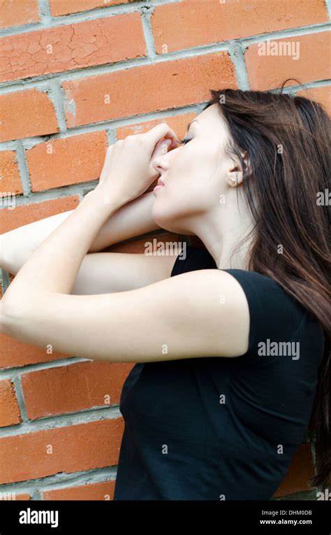 Young Sad Girl At Brick Walls Stock Photo Alamy