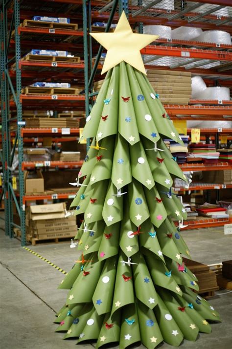 A Christmas Tree Made Out Of Rolled Up Green Paper In A Warehouse With