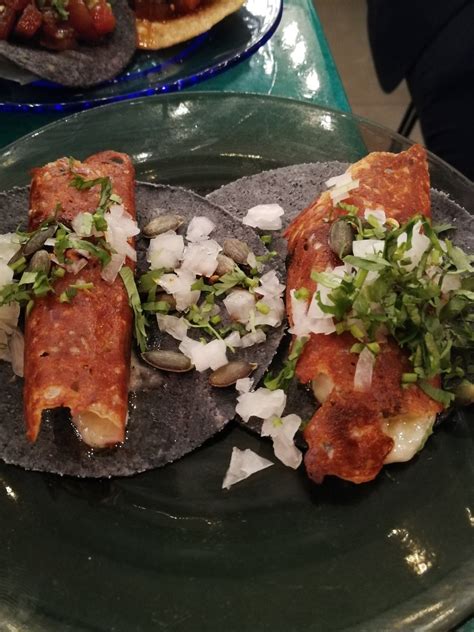 Blackened fish, chile lime sauce, shredded cabbage mix, topped with pineapple relish. London Taco Tour