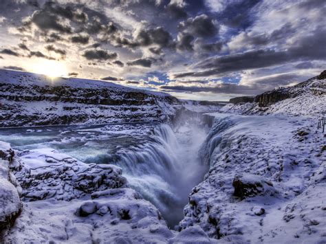Waterfall Crevice Iceland In Winter White Blanket Of Snow Skies With