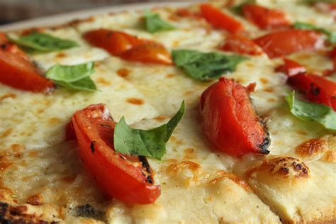 A Classic Margherita Pizza Topped With Fresh Mozzarella Tomatoes
