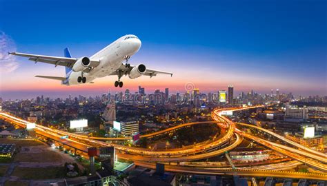 Airplane Take Off Over The Panorama City At Twilight Scene Stock Image