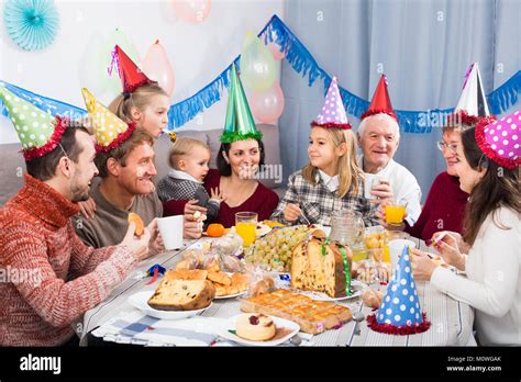 Family are happy to celebrate children’s birthday during dinner Stock