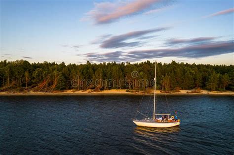 Aerial View Of Sailing White Yacht In Sea Next To Pine Forest Editorial