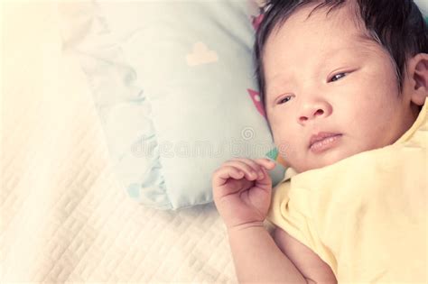 Cute Newborn Baby Boy Is Lying On His Bed Stock Photo Image Of