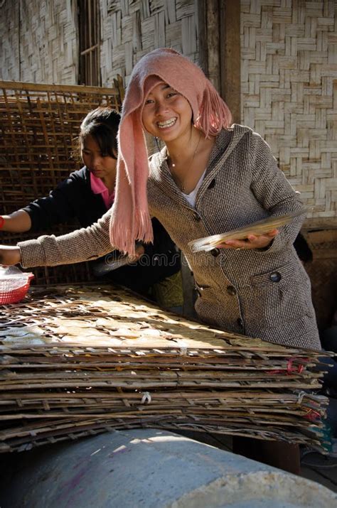 laotian girl setting out rice cakes to dry in vientianne editorial photo image of southeast