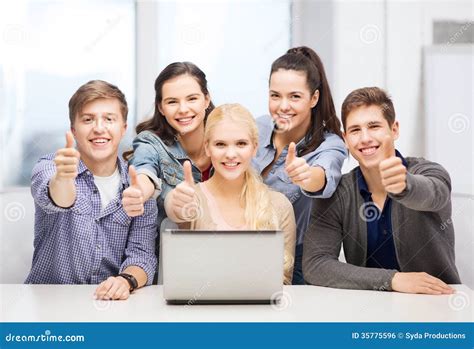 Smiling Students With Laptop Showing Thumbs Up Stock Photo Image Of