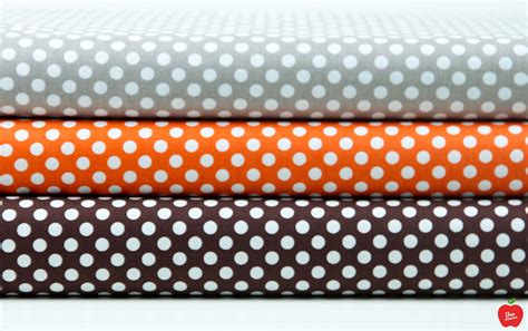 four different colored polka dot fabrics stacked on top of each other