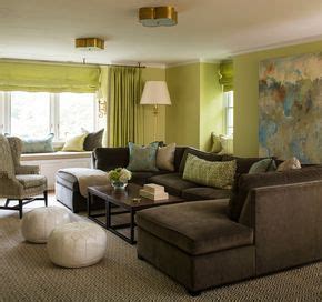 Green and brown living room features walls painted green lined with a a