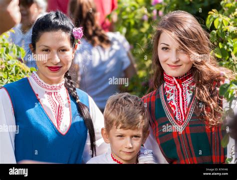 Women Dressed In A Bulgarian Traditional Folklore Costume Picking Roses