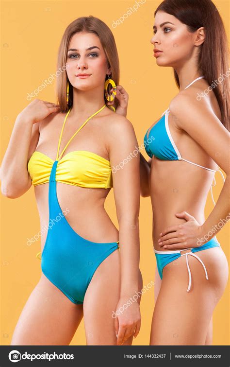 Two Sexy Women In Swimwear Posing On Orange Background Perfect Body