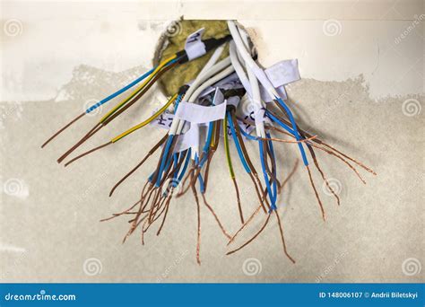 Electrical Exposed Connected Wires Protruding From Socket On White Wall Electrical Wiring