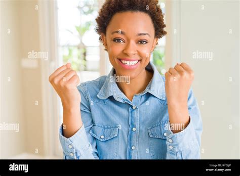 Young Beautiful African American Woman Celebrating Surprised And Amazed