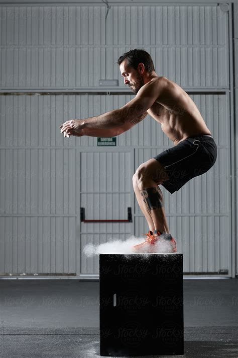 Fit Man Jumping On A Workout Box In The Gym By Stocksy Contributor
