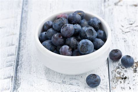 Bowl Of Fresh Blueberries On White Wooden Background Closeup Stock