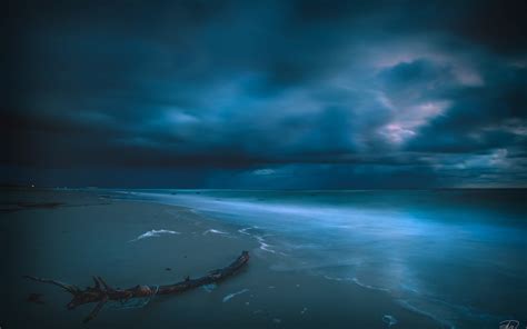 Blue Cloudy Sunset Over Blue Ocean Wallpaper And Background Image