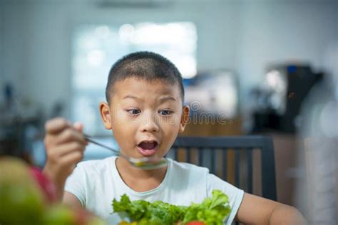 Happy Child Boy Eating Vegetables At Home Stock Photo Image Of