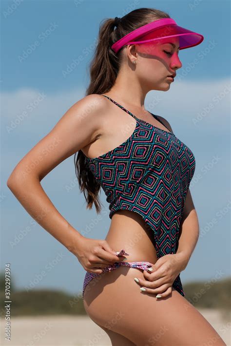 Zdjęcie Stock Sexy woman taking off panties on beach Adobe Stock