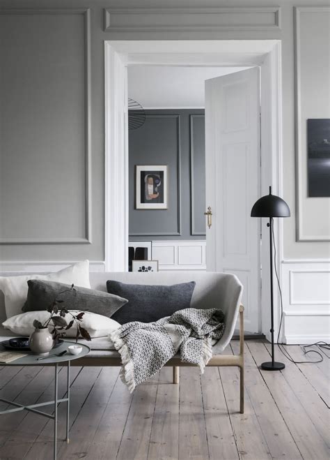 A Living Room With Grey Walls And White Furniture