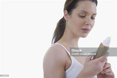Woman Looking At Fake Tan Bottle Stock Photo Download Image Now
