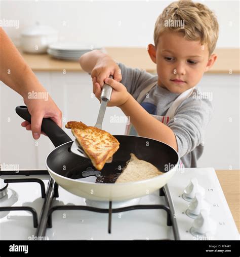 Boy Cooking Eggy Bread In Frying Pan 6 Years Stock Photo Alamy