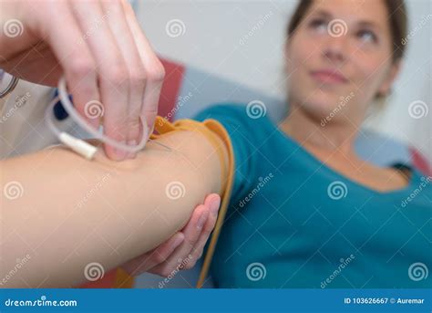 Close Up Doctor Injecting Patient With Syringe To Collect Blood Stock