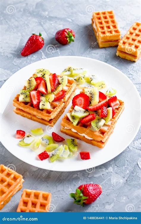 Belgian Waffles With Fruits Strawberries And Kiwi On White Plate