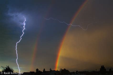 Incredible Moment Lightning Strikes With Rainbow