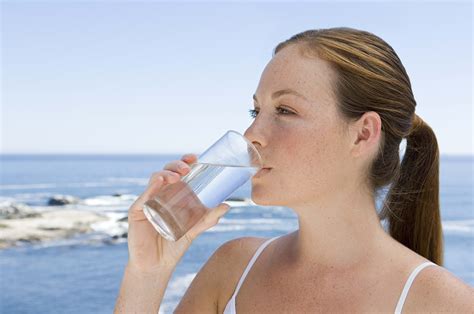 Woman Drinking Fresh Water On Glass Cup During Day Time On The Beach Hd