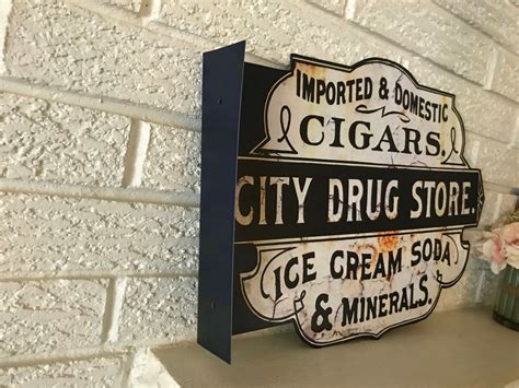 Antiqued Old City Drug Store Double Sided Flanged Country Steel Sign 13