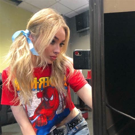 A Woman With Long Blonde Hair Wearing A Spiderman T Shirt