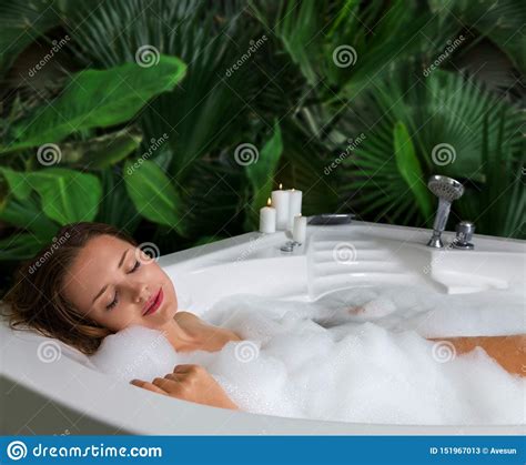 A Woman Relaxes In Hot Bath Tub With Soap Foam Stock Image Image Of
