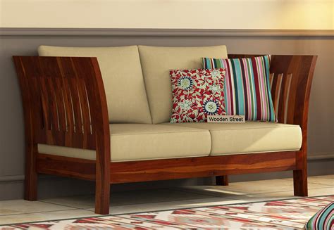 Woodenstreet confers the widest collection of best sofa sets online at lowest price and unmatched offers. Buy Raiden 2 Seater Wooden Sofa (Honey Finish) Online in ...