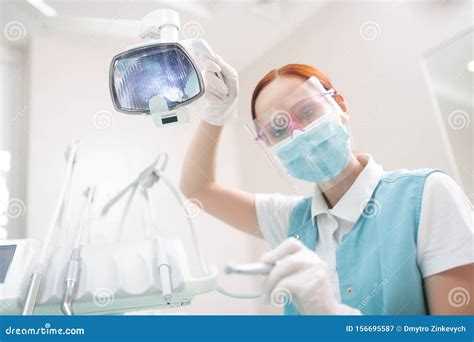 Female Dentist Wearing Protective Glasses Examining Patient Stock Image Image Of Redhaired
