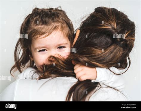 Mother Comforting Her Crying Little Girl On White Stock Photo Alamy