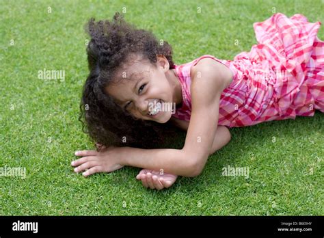 Happy Girl Lying Down On The Grass Stock Photo Alamy