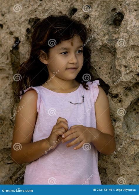 Portrait Of Young Girl Standing Near The Rock Happy Childhood