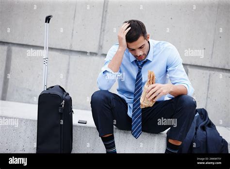 Struggling With Retrenchment A Young Businessman Sitting Outdoors And