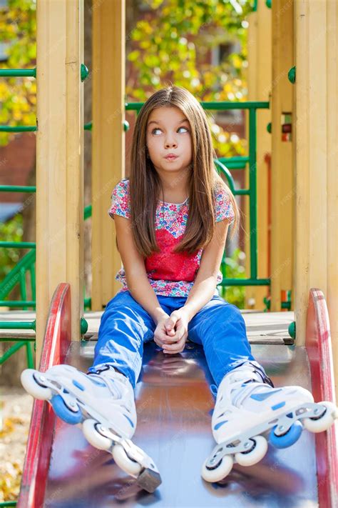 Premium Photo Portrait Of A Tenyear Girl Sits On A Playground In