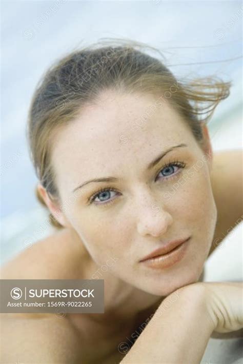 Woman Lying On Beach Looking At Camera Head And Shoulders Close Up