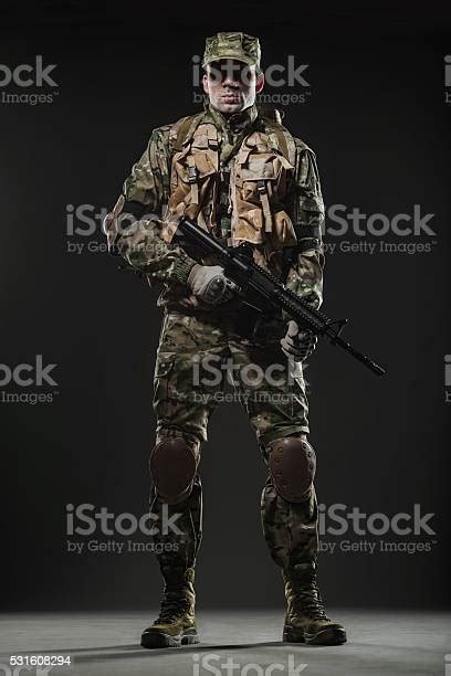 Soldier Man Hold Machine Gun On A Dark Background Stock Photo