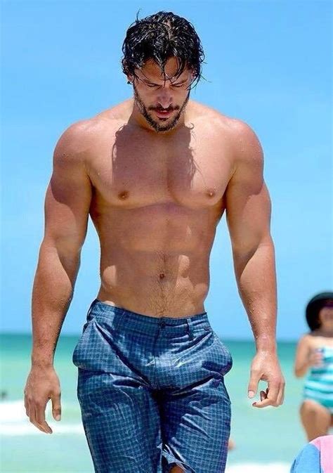 A Shirtless Man Walking On The Beach
